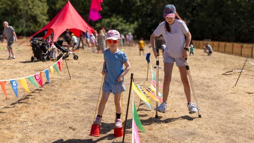 Visitors on stilts as part of Summer of Play at Cliveden
